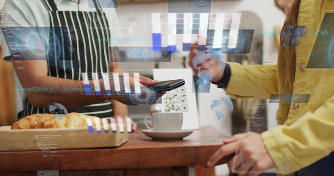 Processing barista in apron holding device while yellow jacket tapping watch paying at cafe counter