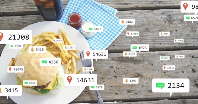 Appearing notification icons flooding across picnic table over plate with burger and fries, fading