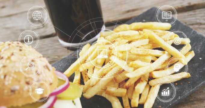 Fading HUD centering on fries, rings revealing sesame burger, cup on wooden table to show menu