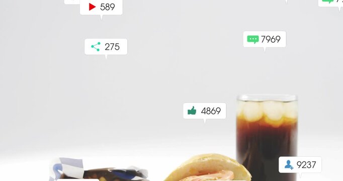 Vertical video: Notification bubbles appearing above burger fries soda on gray table, showing buzz