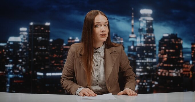 News Host Presents Daily Headlines From modern Television Set, Maintaining Expressiveness and Emotionality and Direct Eye Contact With Audience. Global News Coverage and 24 Hour Information Cycle.