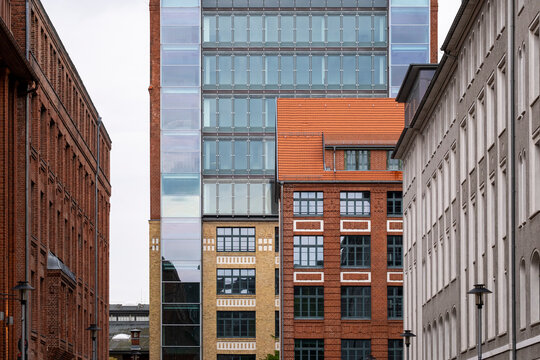 Modern urban architecture along a street featuring red brick building and windows in Berlin Germany capturing city scale and contemporary design character