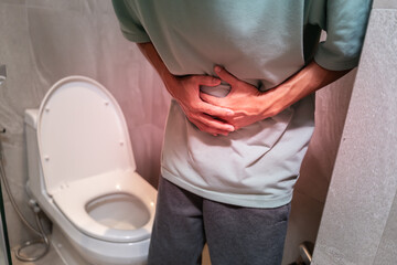Constipation and diarrhea in bathroom. Hurt man touch belly stomach ache painful. colon inflammation problem, toxic food, abdominal pain, abdomen, constipated in toilet, stomachache, Hygiene