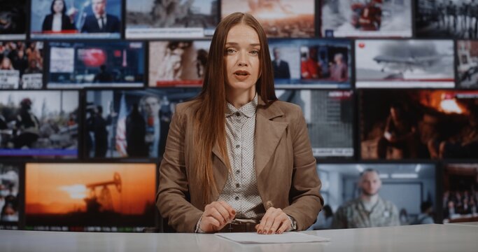 News Presenter Delivers Analytical Report From Modern Newsroom Desk While Background Monitors Stream Diverse World Events. Concept of Credibility, Media Responsibility, and Real Time Reporting.