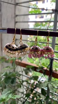 Shiny women accessories. holding silver earring Jumka. Vintage Jewelry Beautiful Earring For Beautiful Lady Multicolor Vintage Spain Jewelry.