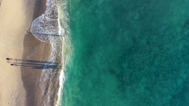 Aerial of person fishing on the beach in San Pancho, Mexico