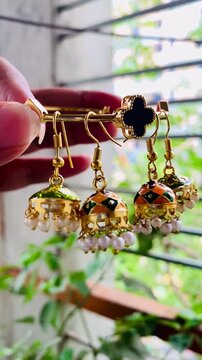 Shiny women accessories. holding silver earring Jumka. Vintage Jewelry Beautiful Earring For Beautiful Lady Multicolor Vintage Spain Jewelry.