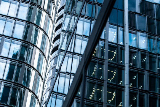 Curved reflection on modern glass facade windows of urban corporate skyscraper creating dynamic architecture background for business city branding