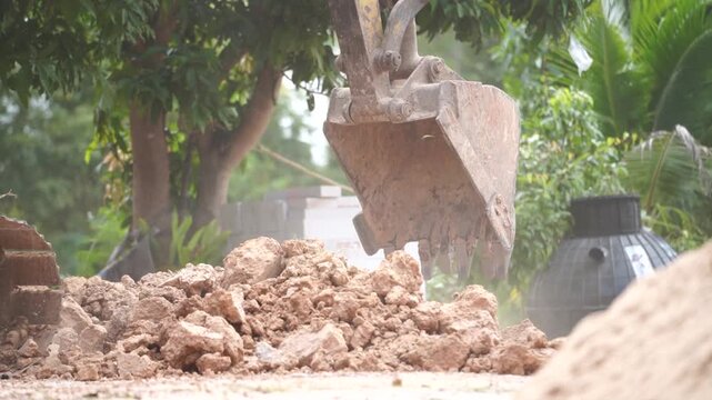 Digging and Construction: A heavy-duty excavator diligently digs into the earth, moving soil, symbolizing construction and industry, with precision and strength. 