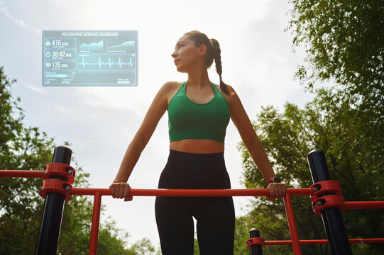 Athlete training on horizontal bar outdoors with futuristic fitness tracking