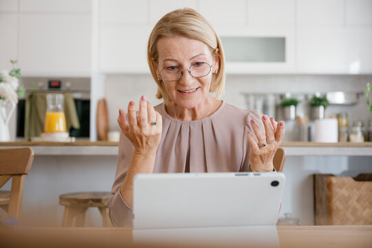 Happy woman having video call therapy session with digital tablet