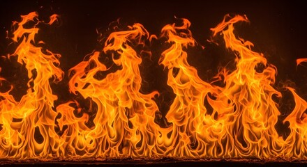 Fototapeta premium Dynamic and fiery orange flames dancing intensely against a dramatic dark backdrop, evoking raw power, warmth, and the mesmerizing beauty of a blazing inferno