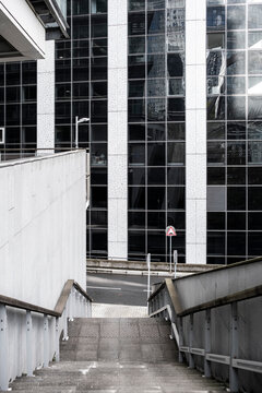 Empty concrete stairway passage in modern office underpass architecture with urban symmetry creating a clean access route and minimalist perspective