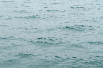 Naklejka premium a close up of a body of water with a boat in the distance