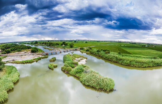 Bridge over the Orange River, near Upington in South Africa's Northern Cape region. Flanked by raisin grape vineyards. Aerial view.