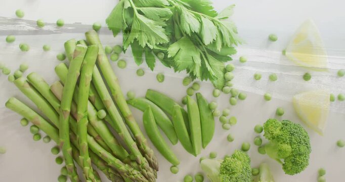 Camera panning over asparagus snap peas broccoli celery peas in plastic bag promoting food content
