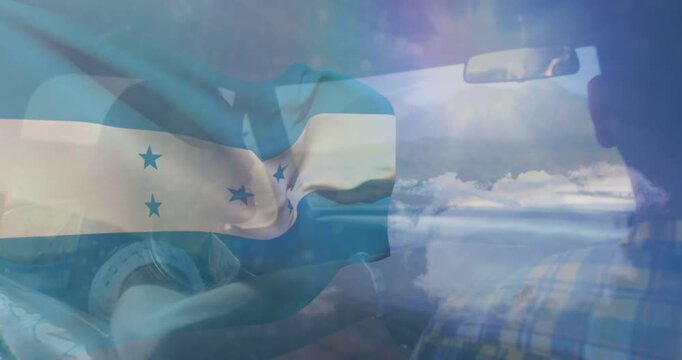 Couple traveling in car, Honduras flag appearing at start and waving over clouds, showing travel
