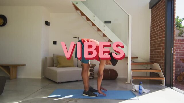 Vertical video: Man starting hip hinge folding to palms on blue mat for fitness, VIBES overlay