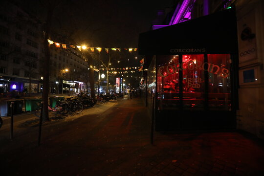 Paris, France - February, 2026. The façade of a Parisian bar by night.