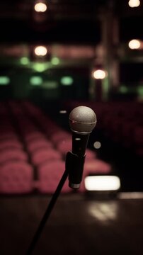 A microphone stands alone on stage, ready for performance. Rows of empty seats await an audience eager for an enchanting opera experience, filling the air with anticipation.