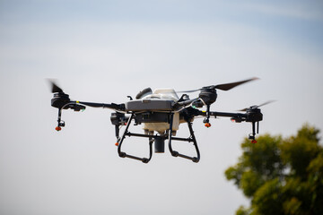 Fototapeta premium Modern smart farming drone flying in the air for precision agriculture spraying