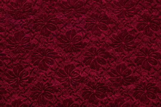 Dark red velvet background with floral pattern