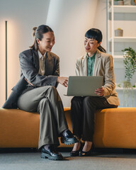 Business women discussing project ideas at informal meeting