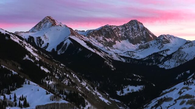 Capitol Peak winter alpenglow vibrant sunset nature panoramic landscape aerial drone Colorado high clouds 14er Aspen Snowmass valley Elk Range last light Rocky Mountains Longs Peak Maroon Bells circle