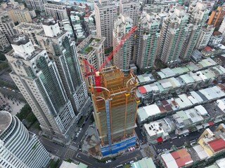 Fototapeta premium Skyscraper construction with crane in city center.