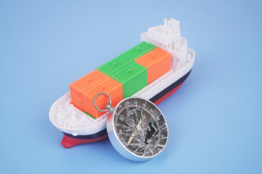 Cargo ship with many containers and broken compass on blue background. Problems with logistics, cargo and sea transportation.