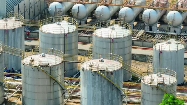 Drone footage showcasing refinery storage tanks and pipeline systems, emphasizing the backbone of energy production during volatile oil prices and shifting global energy strategies.
