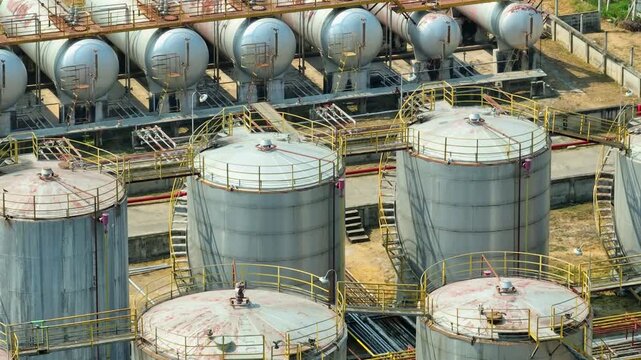 Aerial drone view of an oil refinery with large storage tanks and pipelines, reflecting global energy demand and ongoing supply challenges shaping modern fuel markets and industrial infrastructure.
