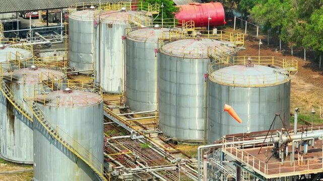 Aerial view of industrial oil refinery structures with tanks and metal piping, symbolizing energy production, fuel supply chains, and the continued reliance on oil in modern society.
