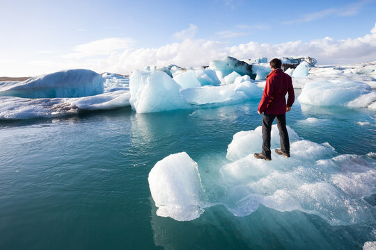 Adventurer standing on glacial ice at J&ouml;kuls&aacute;rl&oacute;n, Iceland