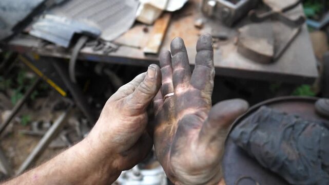 Skilled technician demonstrates precise hand movements while preparing tools for car repair in a garage, showcasing the intricate details of the repair process and the environment