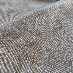 Fototapeta premium Texture of woven fabric close up showing detailed pattern and colors with natural light in indoor setting