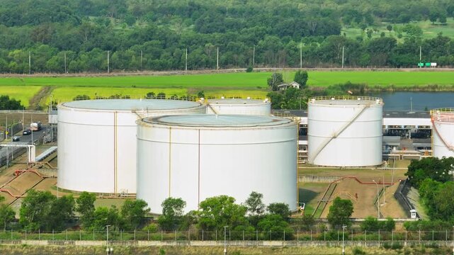 Aerial drone capture of oil storage tanks and industrial systems, representing the balance between traditional fuel reliance and the evolving transition toward diversified global energy sources.
