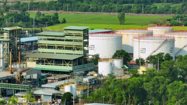 Aerial drone view of an oil refinery with storage tanks and processing units, reflecting rising global energy demand and the need for stable fuel supply in volatile markets.
