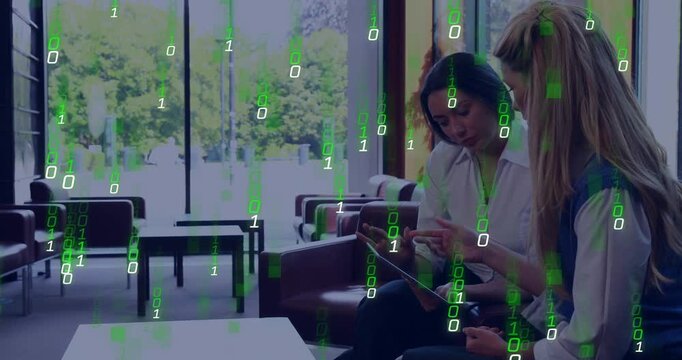 Two colleagues leaning over tablet and tapping, starting green code overlay while testing tech demo