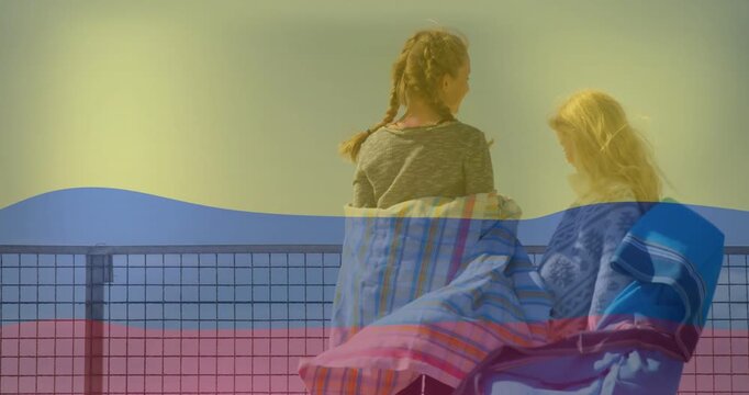 Two girls standing at rail wind lifting towel shifting overlay sweeping fabrics watching sea travel