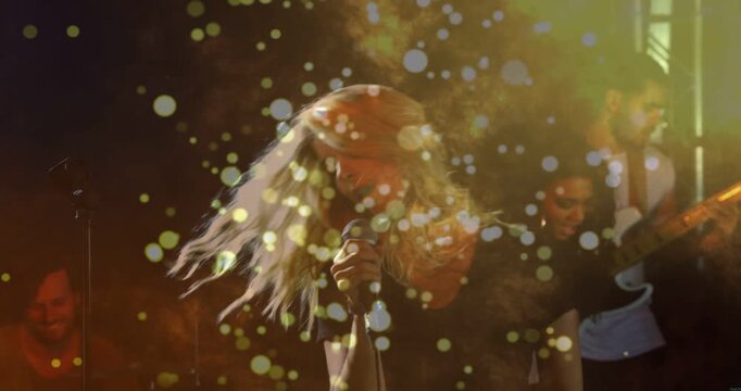 Vertical video: Singing lead singer reacting to music, leaning into mic on club stage, guitarist