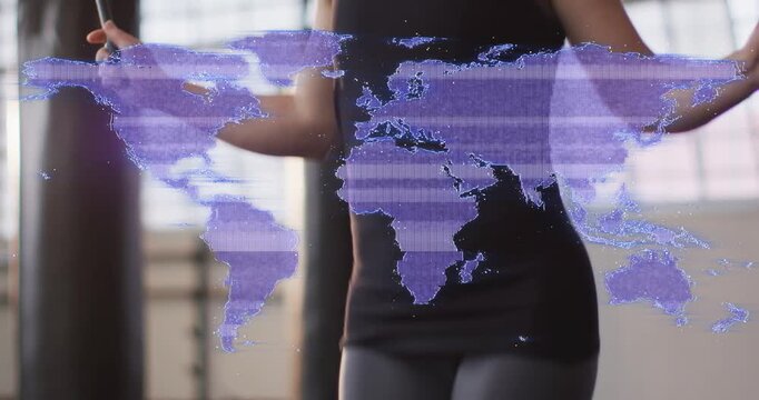 Camera rising, woman in sportswear skipping rope for fitness at studio, purple world-map overlay