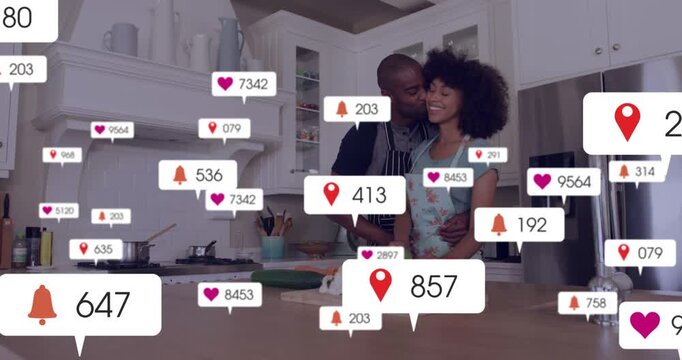 Preparing couple in aprons chopping broccoli on board at kitchen island, with social badges