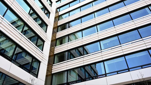 Modern office building glass facade with white horizontal panels