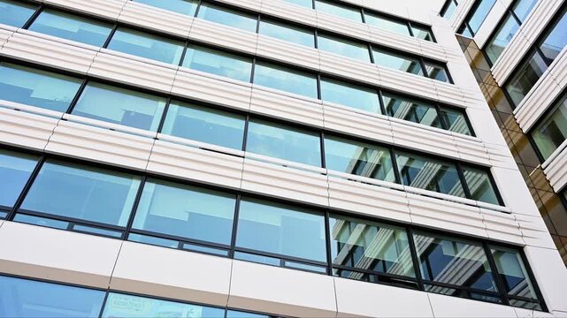 Modern glass facade of office building with white horizontal lines