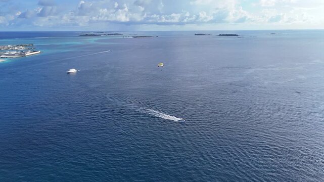 Speedboat Towing Parasail Across Ocean Maldives Water Sports Aerial