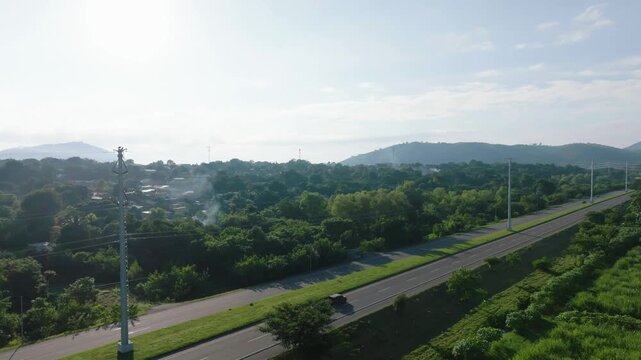 Drone shot of highway and farming land in Honduras, development and transport infrastructure