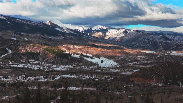 Buttermilk Ski resort Snow League snowboarding ski halfpipe Aspen Snowmass ski town winter sunny cloudy morning aerial drone Colorado ski trail runs Maroon Bells Wilderness forward pan up motion