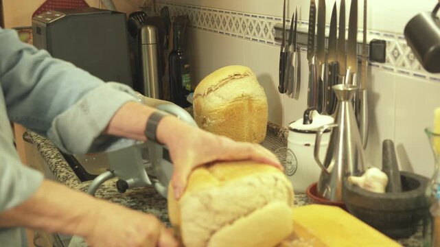 Cutting fresh bread loaf