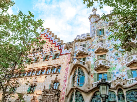 Casa Batllo by Gaudi and Casa Amatller by Puig i Cadafalch in Barcelona. Colorful mosaic facades shine under the sun. Barcelona, Spain - October 10, 2018